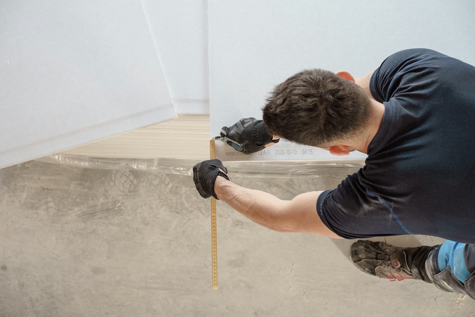 Carpenter measuring timber on site